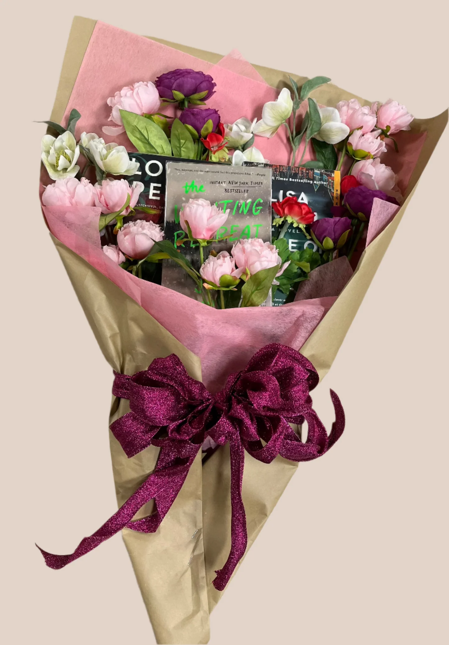Three paperbacks wrapped in kraft paper with dried flowers and twine